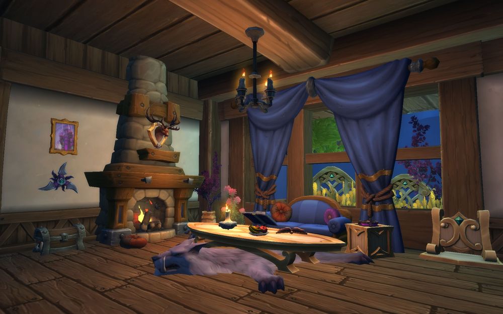 A cozy loving room in World of Warcraft featuring a large fireplace, a large window with blue curtains, a blue sofa with throw pillows, and a long elven inspired coffee table. There are fantasy objects hanging on the walls and laying on tables as decor.