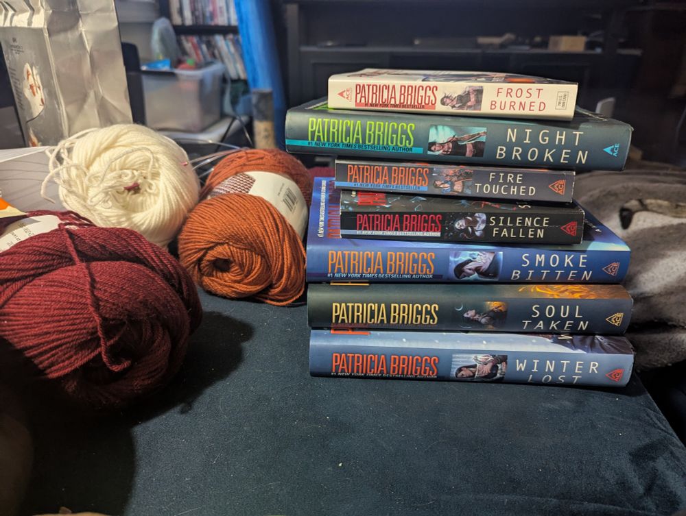 A seven-high stack of Mercy Thompson novels by Patricia Briggs.