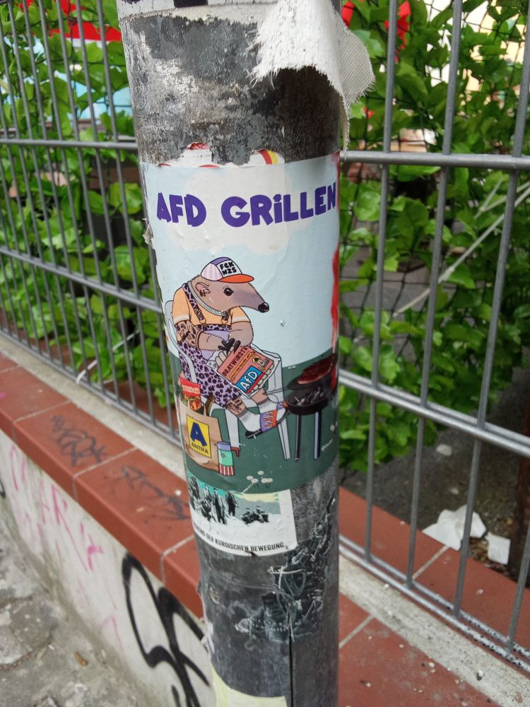 Affiche "AFD grillen", avec un personnage allumant un barbecue.
