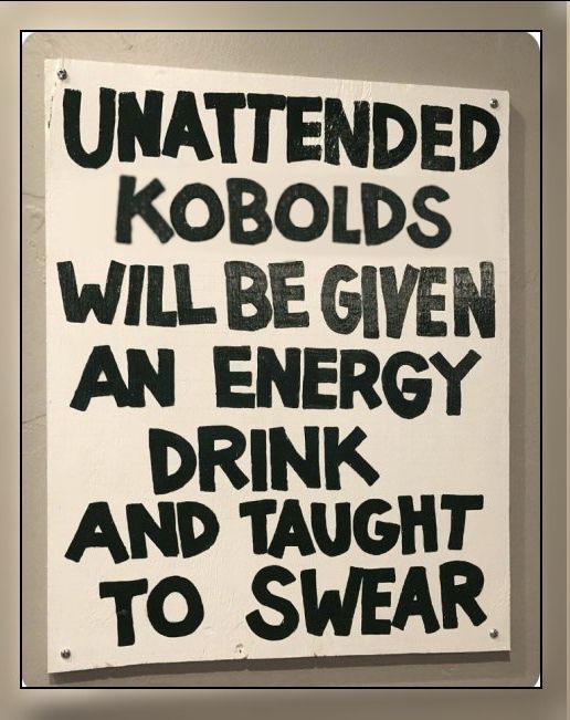 Hand drawn black paint sign saying "UNATTENDED KOBOLDS WILL BE GIVEN AN ENERGY DRINK AND TAUGHT TO SWEAR"