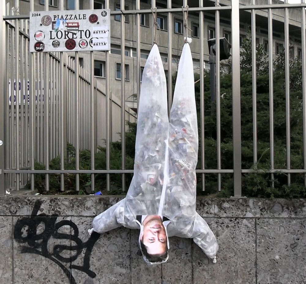 Elon musk effigy hung upside down in Milan. The effigy is made of trash, just like Elon