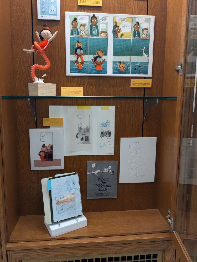 Vitrine with a model small model of Roberta being held up by a tentacle. Palette ideas and sketches for Roberta and the Crane claw; poem The Snowman by Shel Silverstein—inspiration for Team Pom's doomed Synchronized Swimming routine