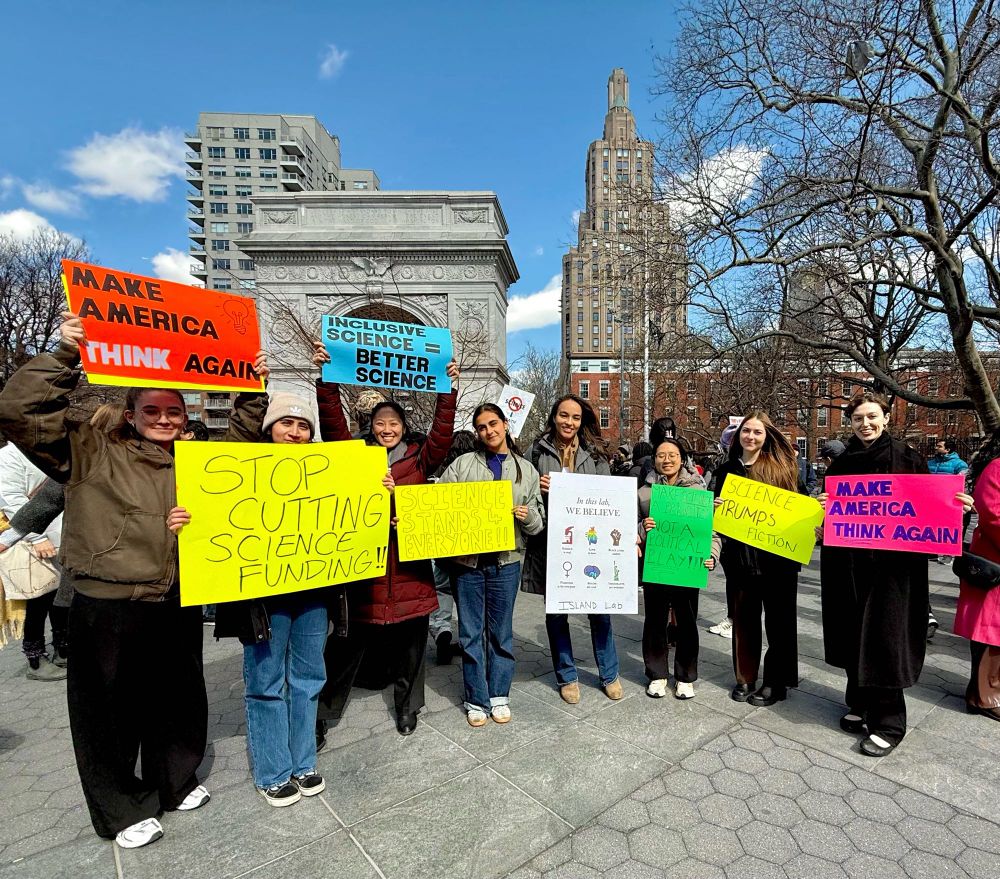 Scientists holding up signs at rally in Washington square park