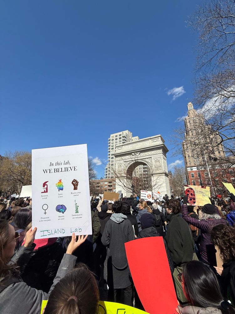 Scientist holding up sign at protest rally