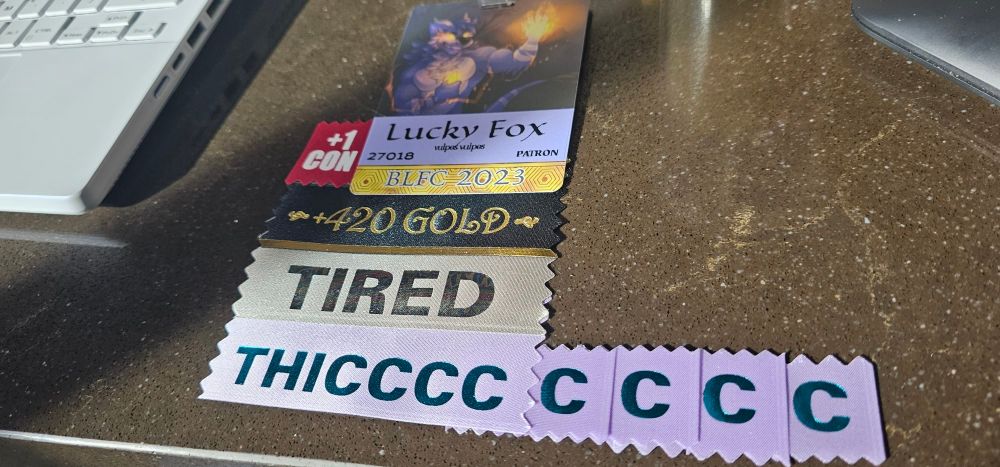 BLFC Badge for Lucky Fox, Patron, with ribbons indicating +420 gold, +1 con, tired, and Thicccccccc