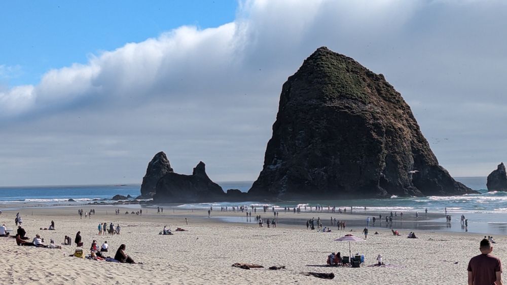 haystack rock at cannon beach Oregon, people waiting for the cougar to escape the rock