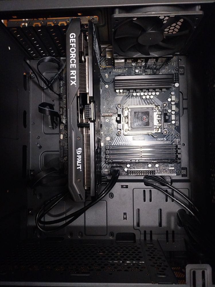 The inside of a desktop computer is still being set up. Lacks a processor, cooler and power source.