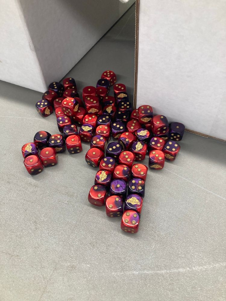 Loose spill of red-purple d6 with the GameHole Con logo