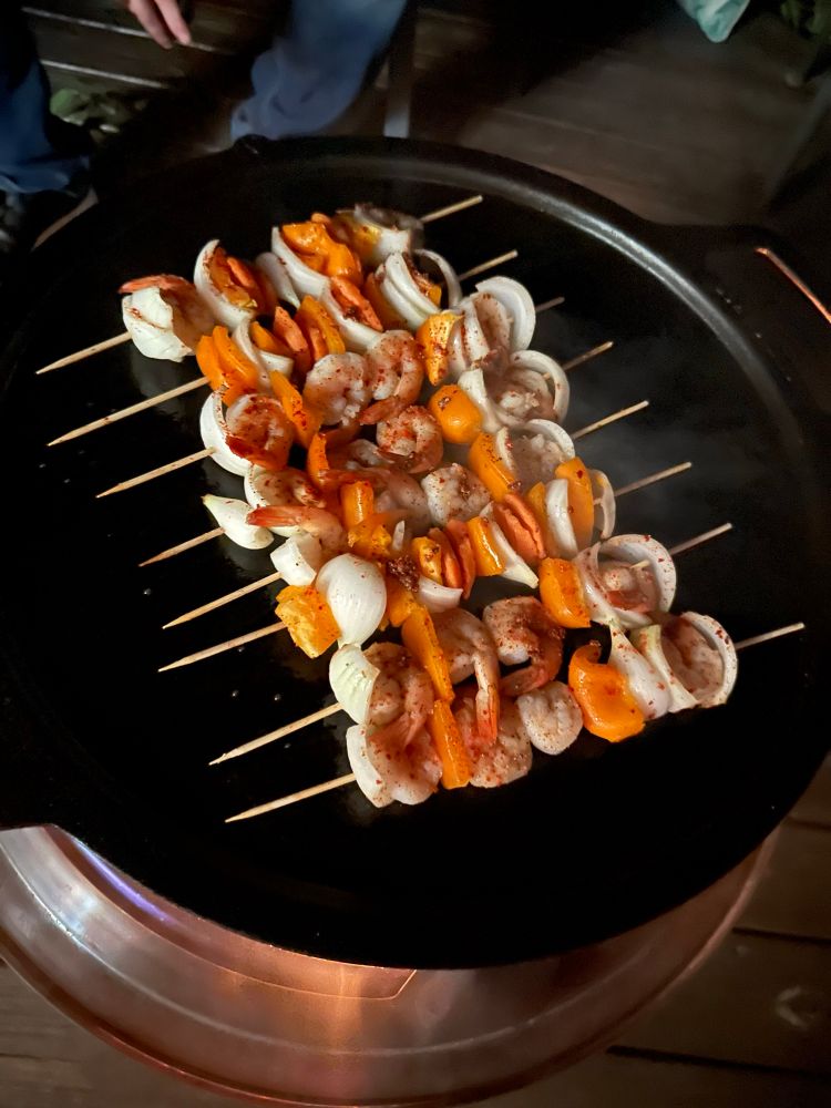 Skewers with shrimp, bell pepper, and onion.