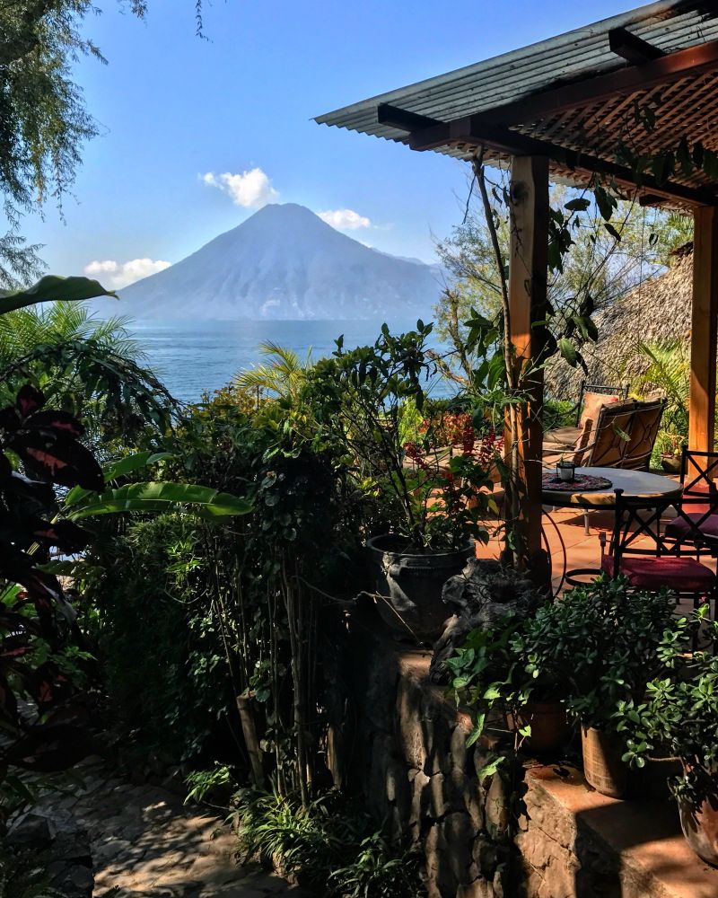 The incomparable Lake Atitlán in South Guatemala. Picture is of a small hut with a chair on a patio overlooking the volcanos that rim the lake. 