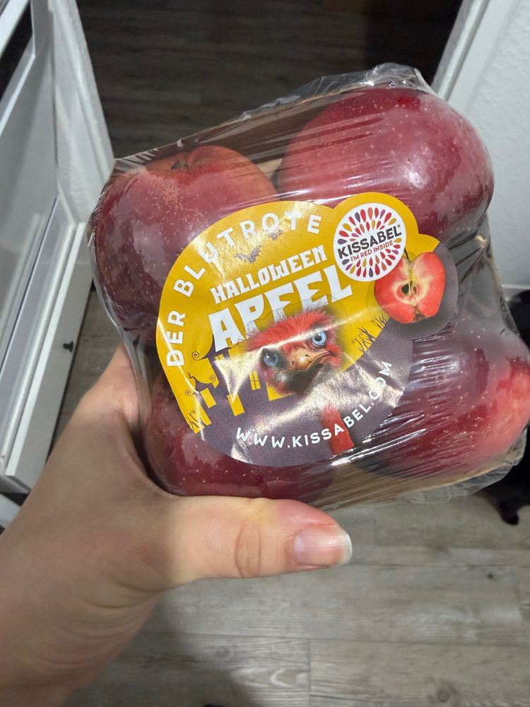Pacote com quatro maçãs de Halloween, com rótulo em alemão escrito as maçãs vermelho-sangue de Halloween. 