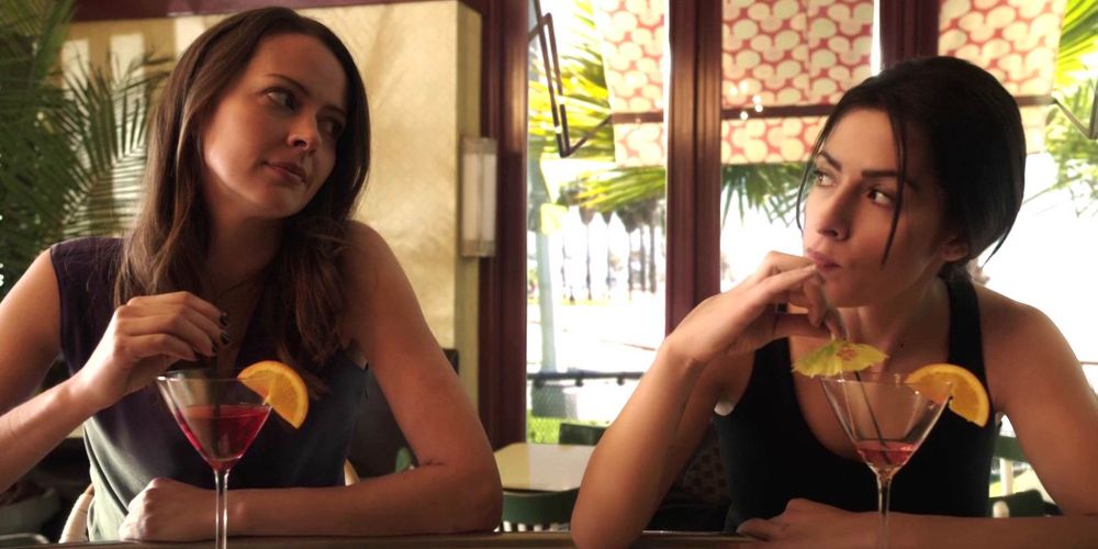 Root and Shaw from Person of Interest sitting at a bar having cocktails.