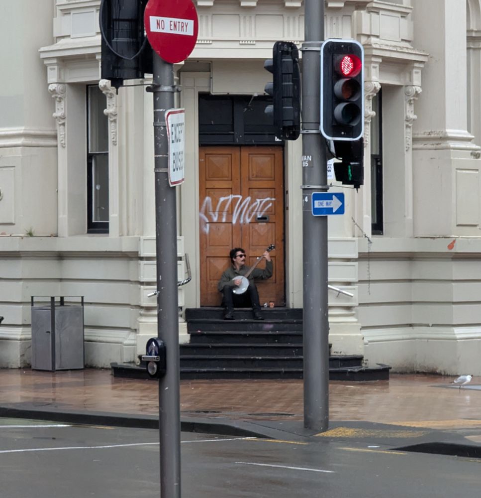 Banjo, man, rainy Street