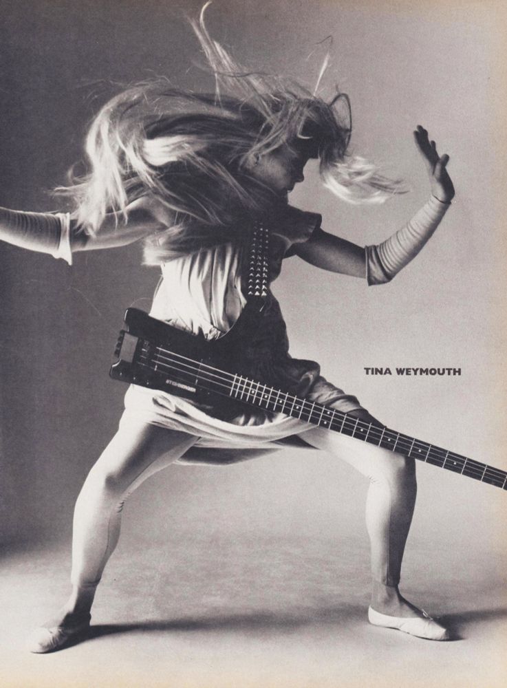 b&w photo of the bassist - caught in movement, her head surrounded by a storm of blonde hair