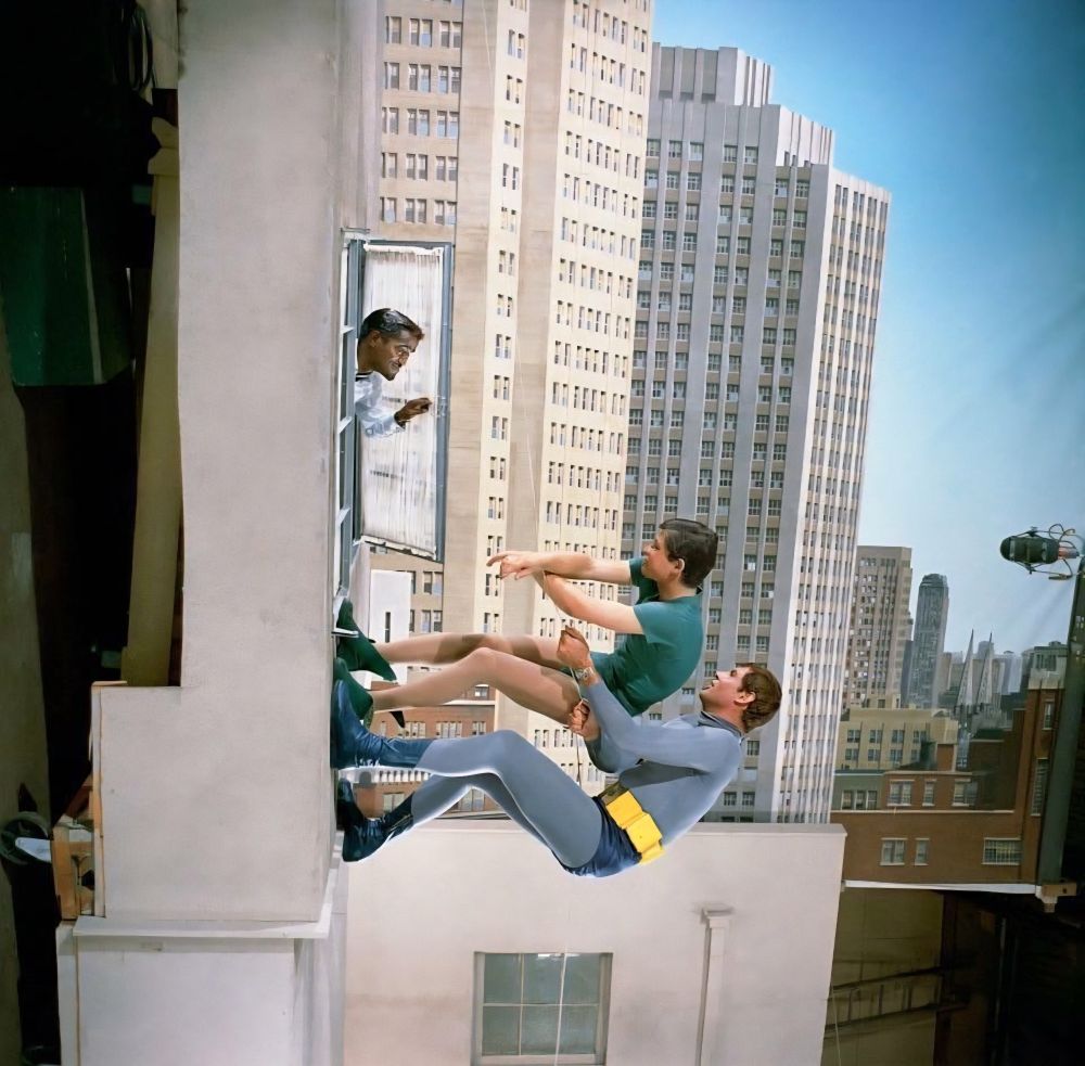 Adam West and Burt Ward climbing up the side of the building and Sammy Davis Jr opening up a window to pick his head out and say hi okay yes I admit this is commonly clever special effects 