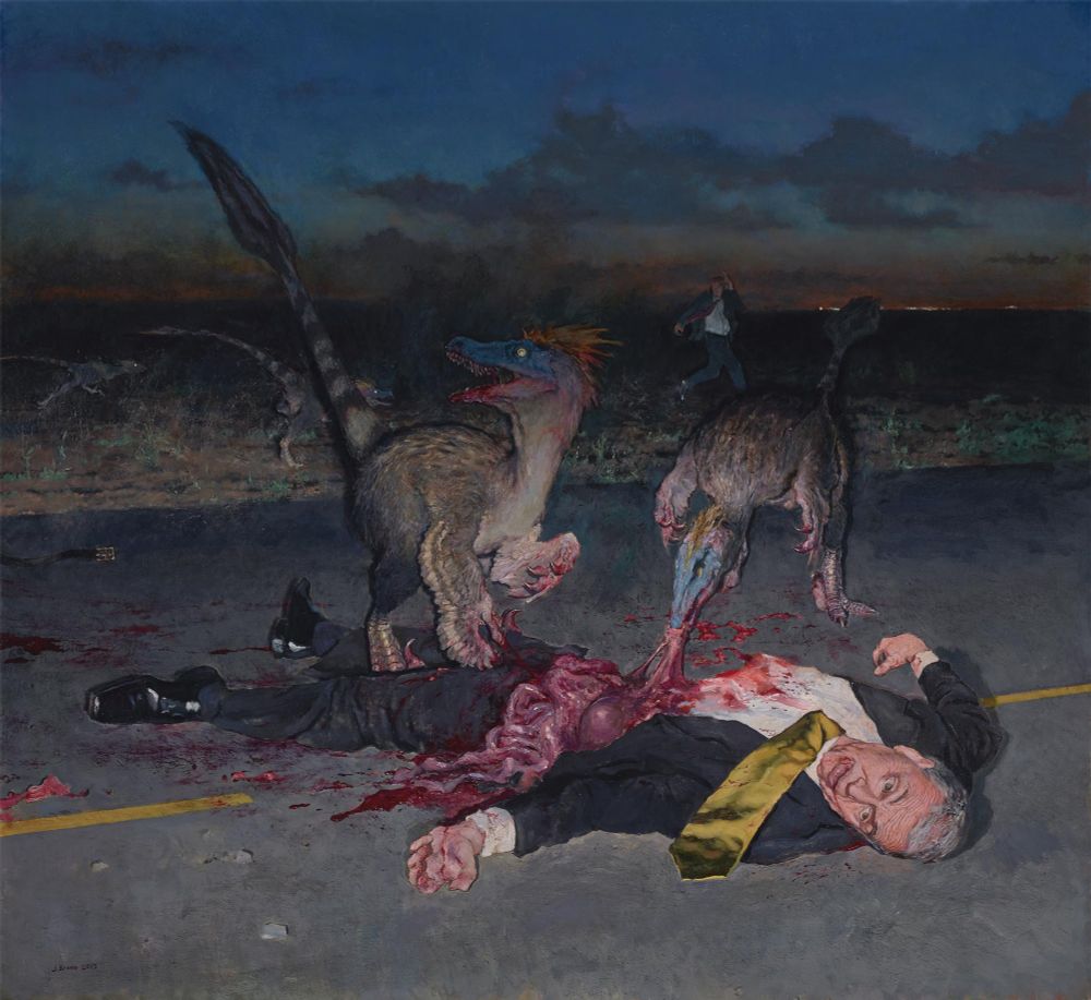 A man in a suit is lying is in the middle of a road. He has been disemboweled by a couple of velociraptors. (I think they're velociraptors, but I'm no dinosaur expert.) At the side of the road another man in a suit is fleeing from a couple more dinosaurs. The lights of a town are visible in the distance.