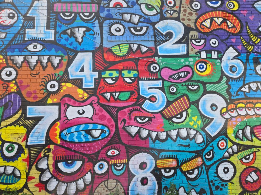 Wall art. monsters and numbers crammed together 