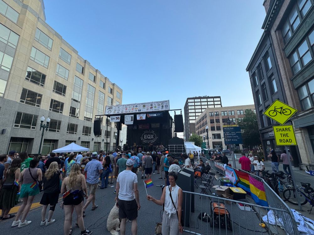 Neal Francis playing at Alive at Five in downtown Albany. Pride flags adorn the scene.