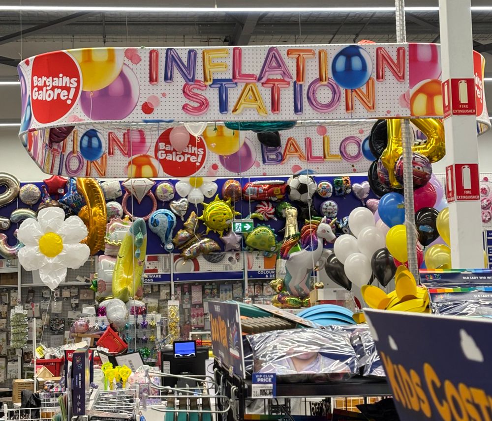 The balloon desk at Spotlight DFO Essendon with banner “Inflation Station”