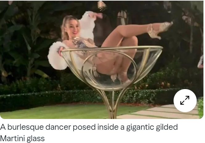 A scantily clad burlesque dancer at the party poses in a "gigantic gilded martini glass." Her ass is raised, and her crotch is fully visible. (The videos being shared on SM are much more alarming than this photo; the women all look like brothel workers.)

Source: https://www.yahoo.com/news/articles/trump-under-fire-great-gatsby-192606675.html