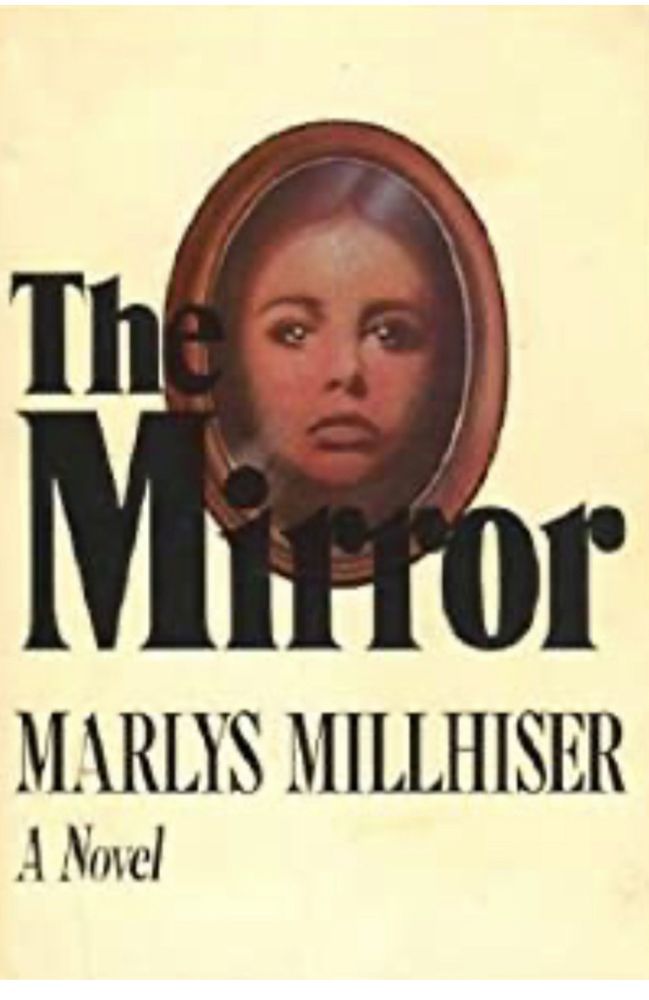 Yellow background with an oval wooden picture frame. A young woman’s face is reflected in the mirror inside the frame. “The Mirror” is written in black letters and below, the author’s name, Marlys Millhiser. A novel. 