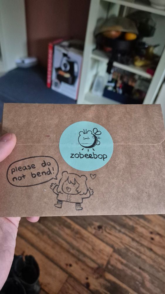 A photo showing the card I got with an airfryer in the bg