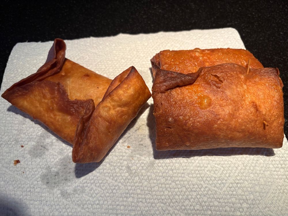 Freshly fried pizza puffs. Left one is a taco tortilla because I ran out of burrito tortillas and the right one was a little overdone