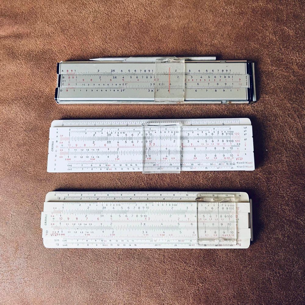Trio of slide rules with Addiators attached. 