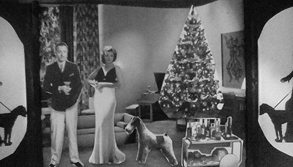 Inside THE THIN MAN magnetic playset: inside their Manhattan hotel (complete with removable Christmas tree) Nick and Nora Charles greet you with little dog Asta at their side. A rolling cart of drinks is on the right