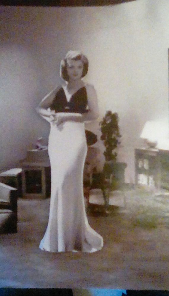 Inside THE THIN MAN magnetic playset, Nora Charles looks stunning in her floor-length sleeveless gown. She think you could probably use a drink