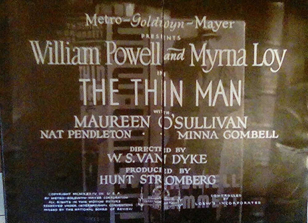 Lid of THE THIN MAN magnetic playset: it mimics the title screen/credits of the movie and the doors open in the middle