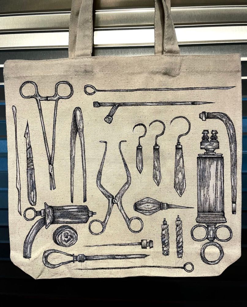 medical and mortuary tools evenly spread out drawn by me on a canvas bag hanging on ribbed stainless steel.