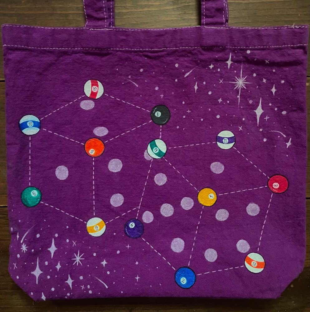 pair of dice constellation with pool balls as main stars and dotted lines connecting them with sparkles top right and bottom left on eggplant dyed canvas tote bag