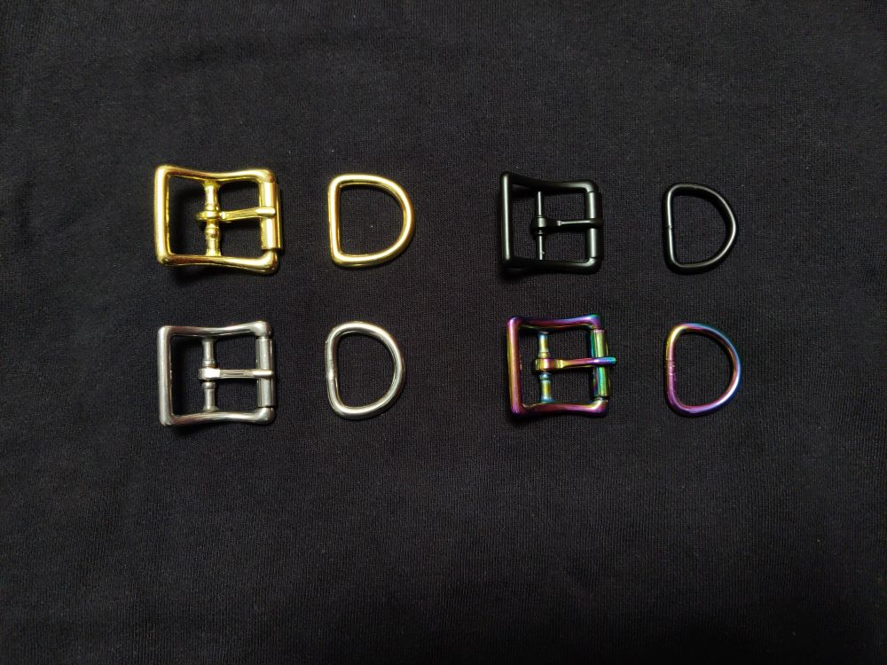Four pin buckles with matching D rings here. 

Top left: solid brass, nickel free, not suitable for latex wear

Top right: black, zinc alloy base, contains nickel, not suitable for latex wear

Bottom left: stainless steel. Hypoallergenic, suitable for latex wear

Bottom right: rainbow. Anodised stainless steel. Hypoallergenic, suitable for latex wear.  