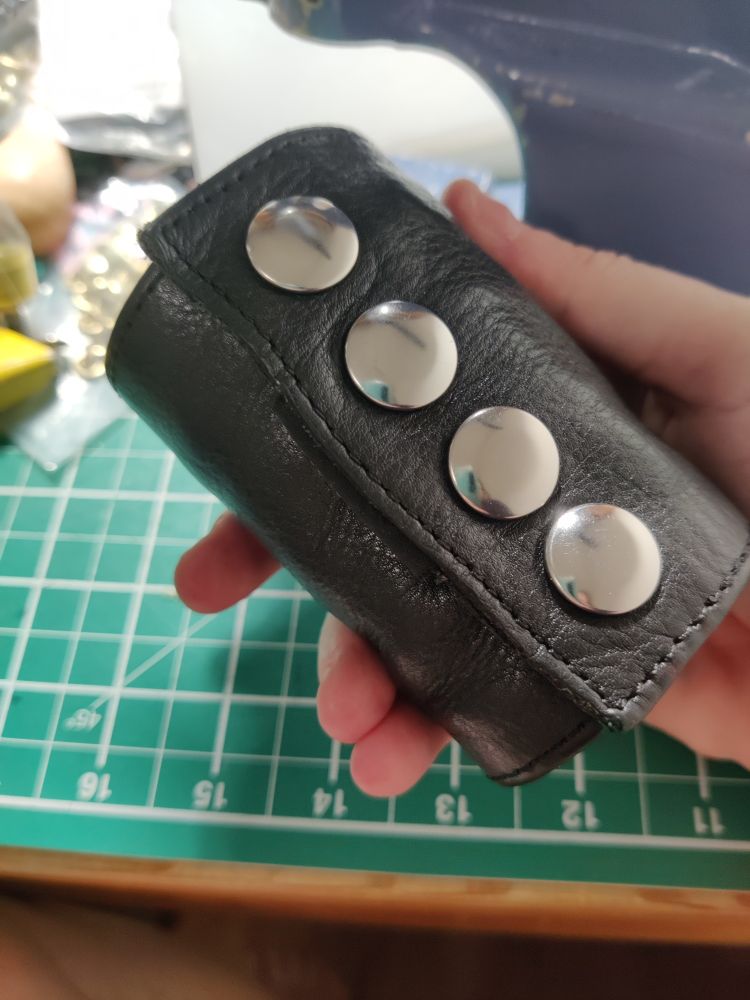 Finished refurbishing, and here the press studs snapped together so it's now cuff shaped again. Shiny! This should last for decades without repair, now. 