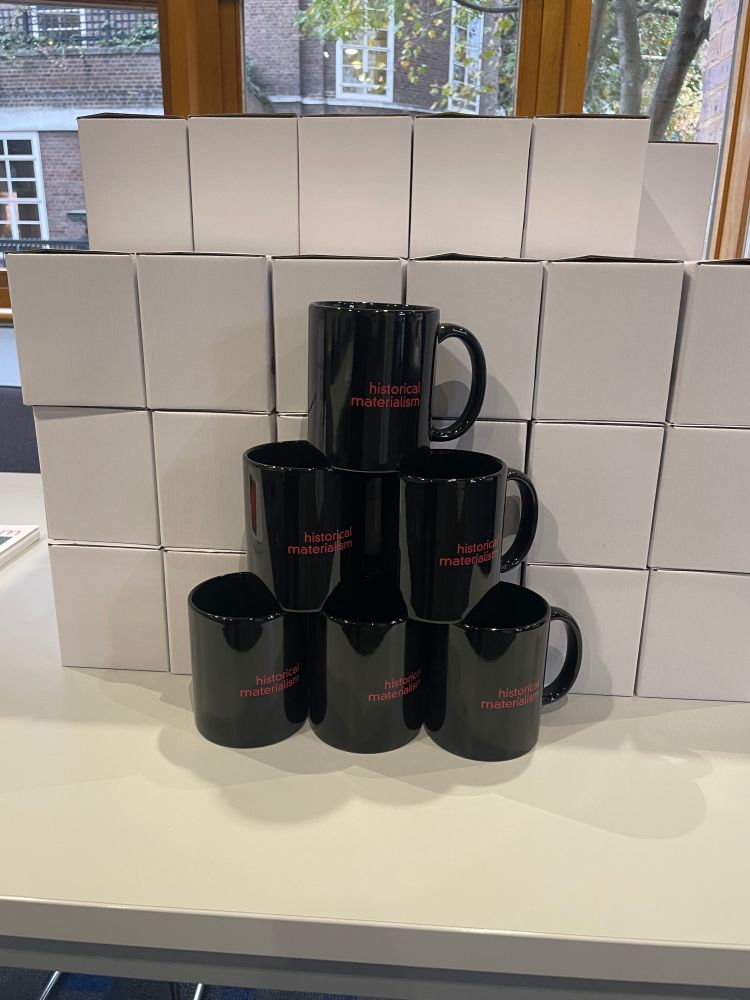 A pyramid of mugs with the Historical Materialism logo printed on it.