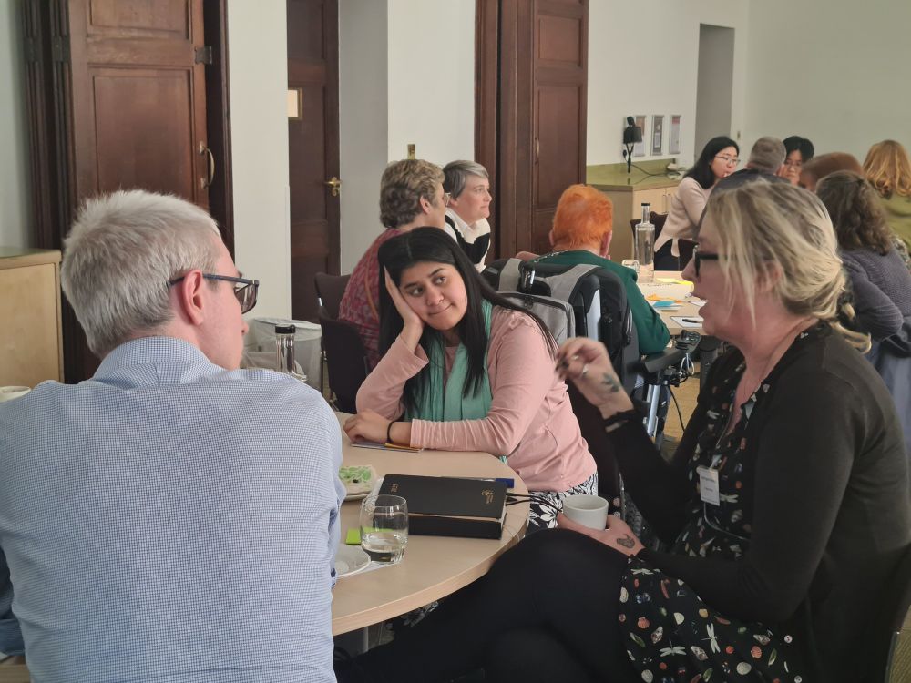 Attendees at the event talking round a table