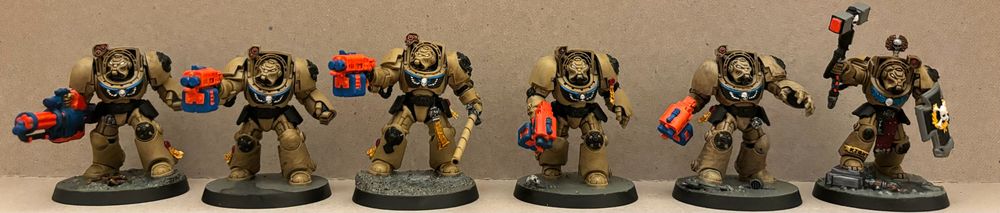 6 Warhammer 40,000 figures, painted the color of undyed cardboard with Nerf weapons and a cardboard tube sword. 