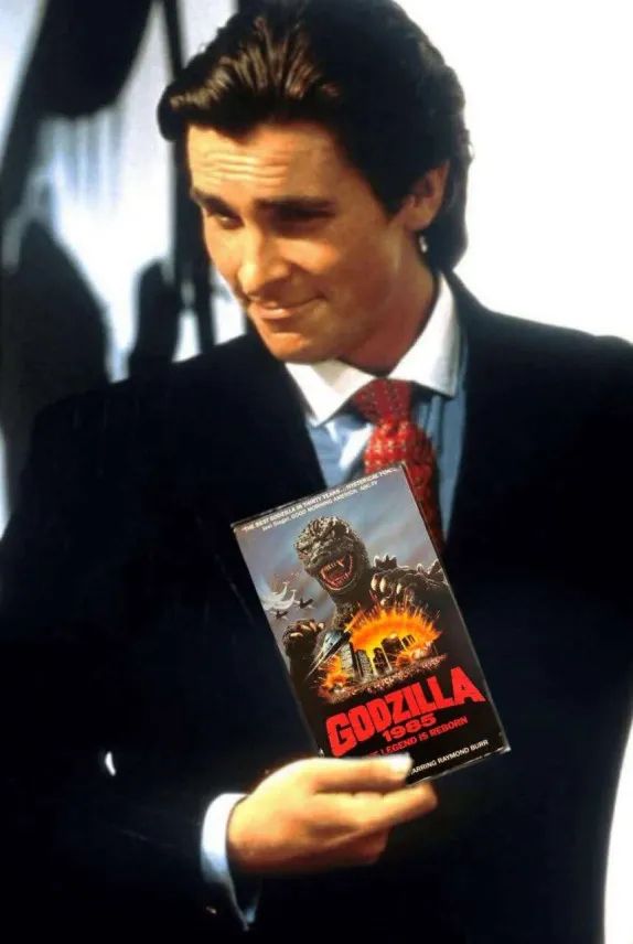 Patrick Bateman from American Psycho holding a video of Godzilla 1985