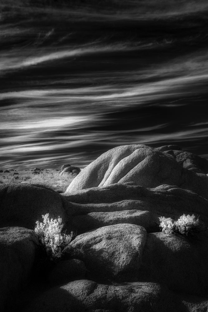 Rock formation in the desert at sunset. A black and white infrared image of shadows and light.