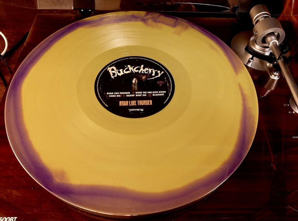 12" green & purple merge vinyl LP of "Roar Like Thunder" by Buckcherry, on an ION turntable.