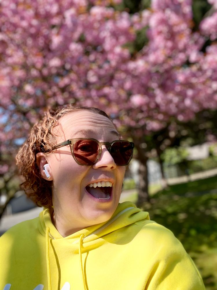Blurred plum tree landscape as a backdrop for a quick happy selfie. 