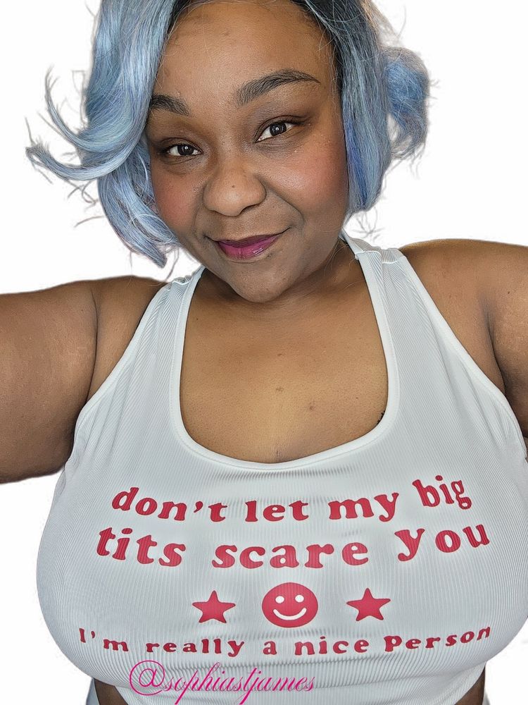 Ebony model with big tits in a white tank top.