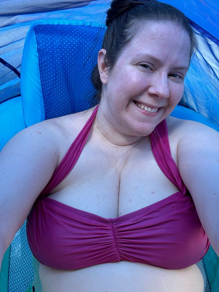 Me, basking in the blue glow of my pool lounge’s blue canopy