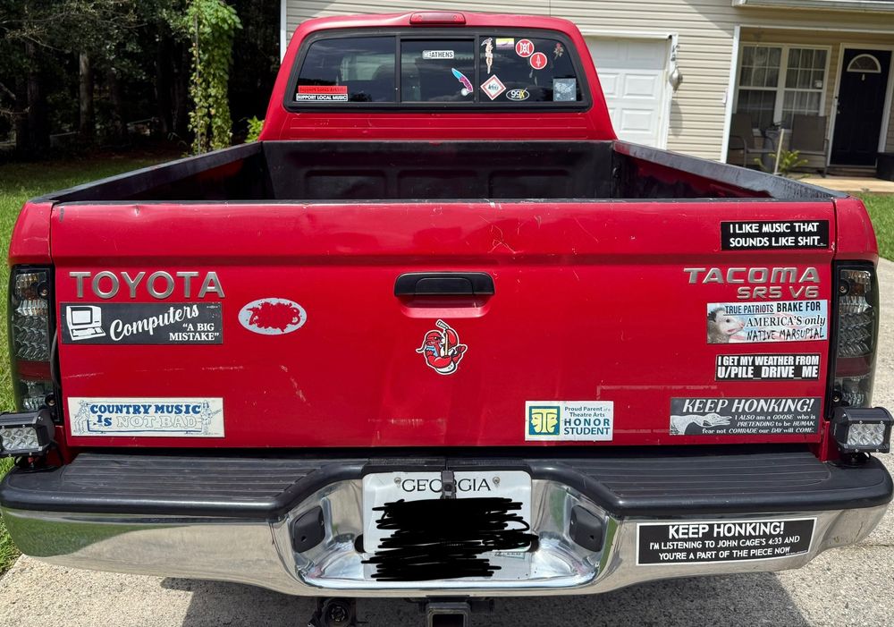 a pickup with a number of bumper stickers