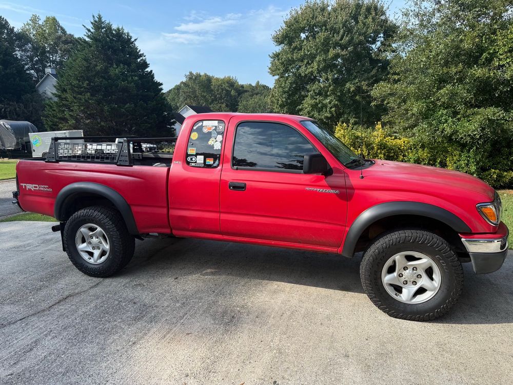 a red 2004 tacoma with a bed rack