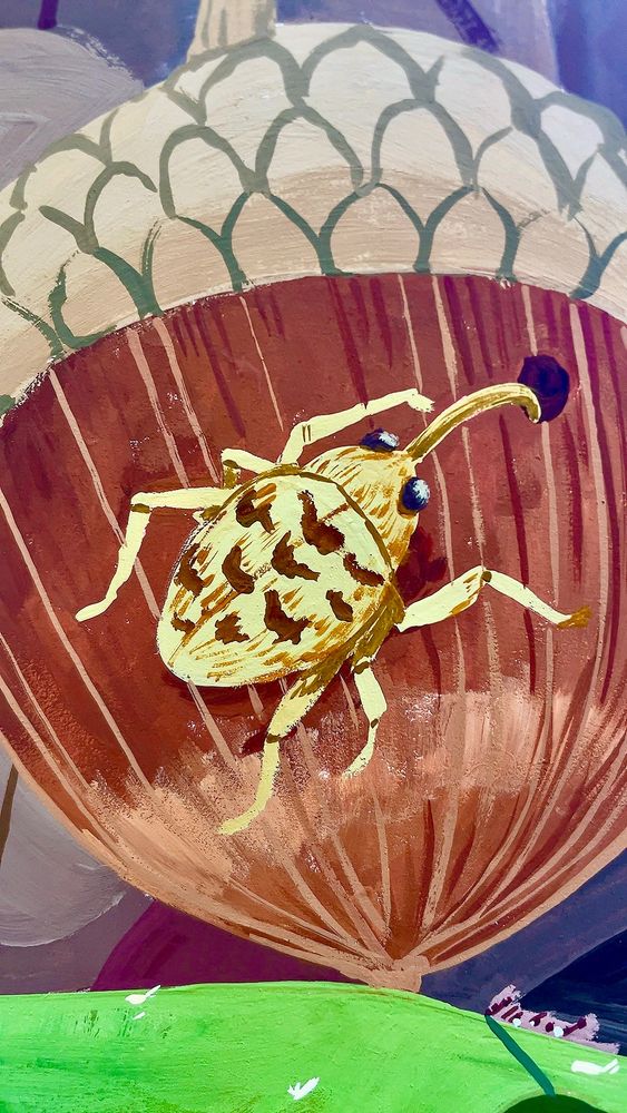 Close up of a painting featuring a golden acorn weevil drilling into a white oak acorn, rendered in intricate patterns and bright colors.