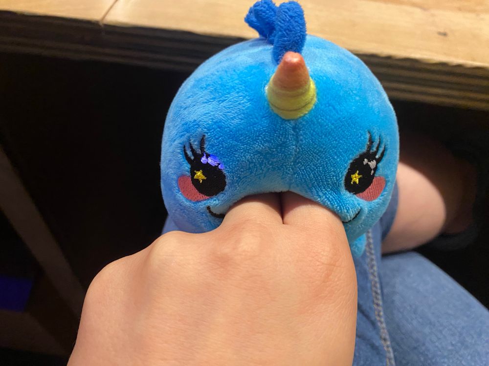 two fibgers have been unceremoniously shoved i to the narwhal's gaping mouth