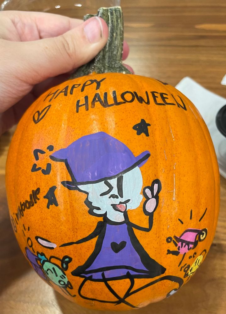 A ram dressed up as a witch is posing playfully