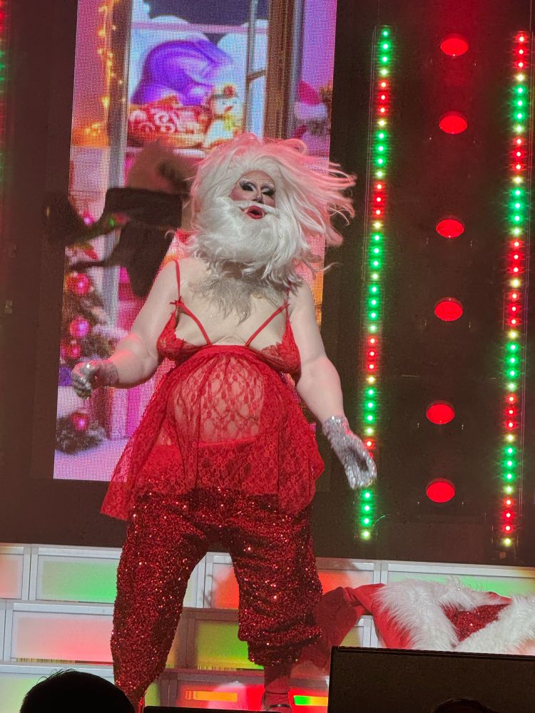 Jimbo the Drag Clown as a crossdressing Santa in a red lacy teddy, red sequin pants and floppy man titties